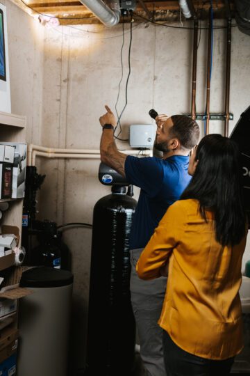 Clear Pest Pros uses flashlight to inspect home